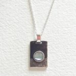 Pendentif rectangle création pièce unique en argent patiné noir et gravé main avec un petit cercle de nacre serti